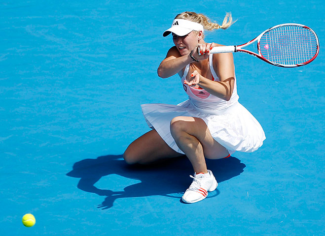 Melbourne Day 11: Caroline Wozniacki of Denmark returns the ball to  Li Na