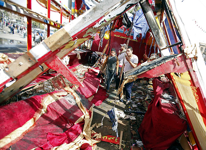Egypt violence continues: People walk through a destroyed market in the port city of Suez