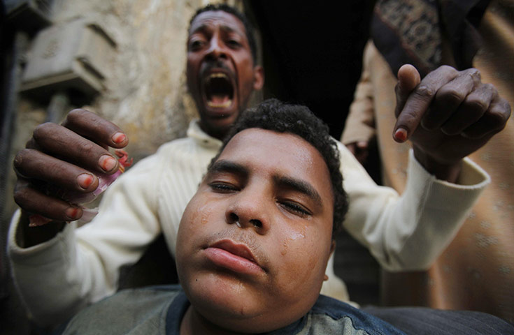 Egypt Protests: An anti-government protester reacts as his relative is injured