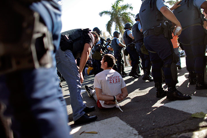 24 hours in pictures: A demonstrator talks to a police officer at Capitol building in San Juan