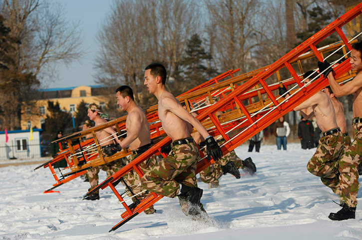 24 hours in pictures: Firefighters of the Changchun fire brigade participate in a drill in snow