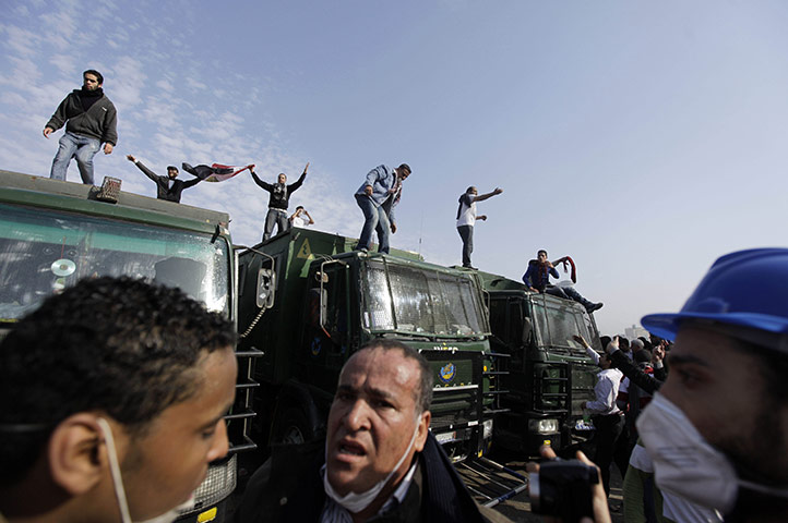 Protests in Egypt: Egyptian anti-government activists are seen atop police trucks
