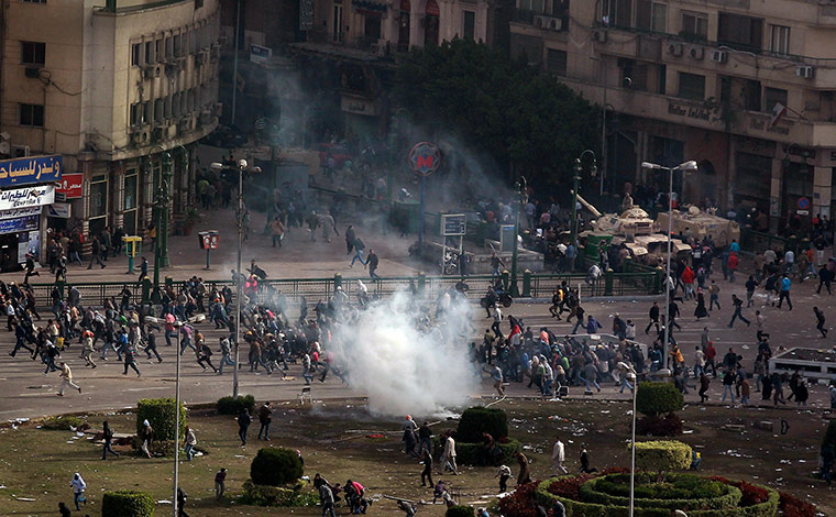 Egypt 29 January: Protestors flee a volley tear gas in Tarhir Square