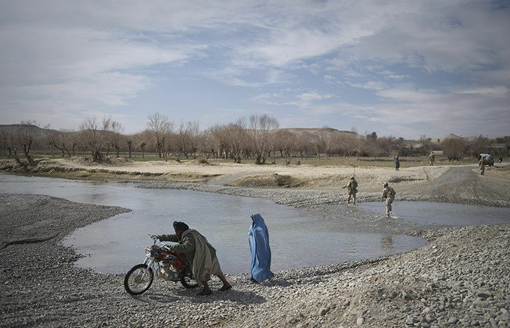 24 Hours: Afghans and US Marines from 1st Battalion, 8th Marines cross a river