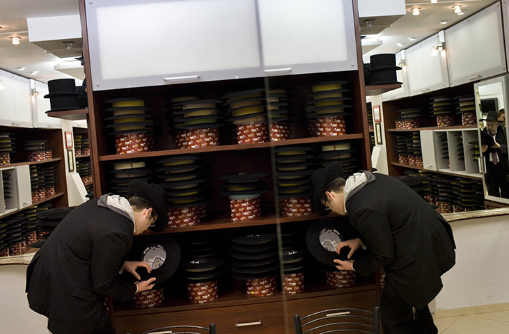 24 hours: Jerusalem: An Ultra Orthodox Jewish boy selects a hat in a store