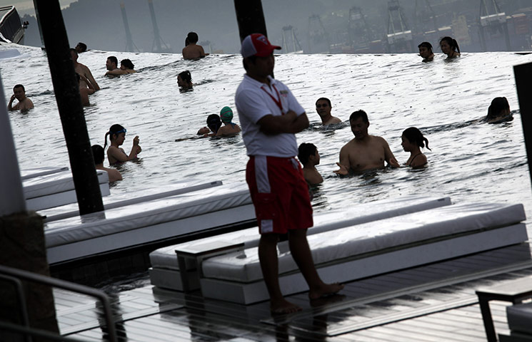 24 hours: Singapore: Tourists relax in an infinity pool at the Marina Bay Sands Hotel