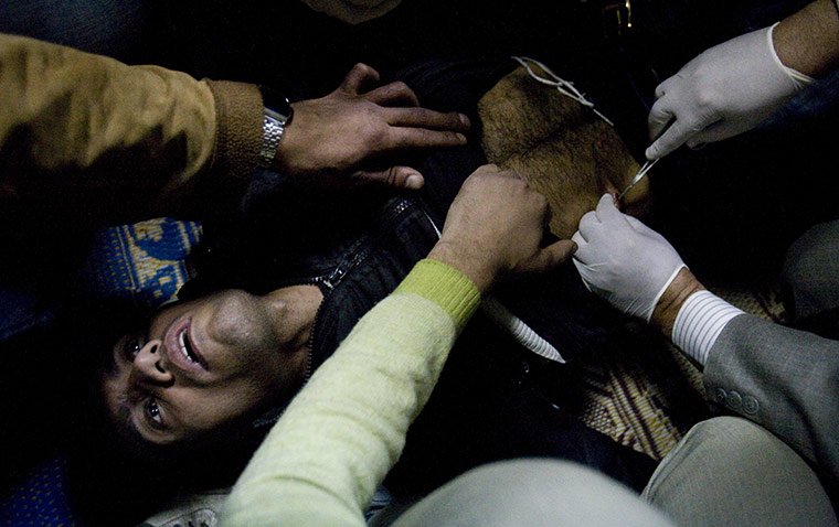 wounded cairo protesters: protester treated for gunshot wounds