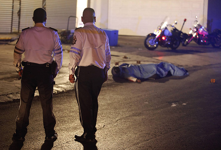 24 hours in pictures: traffic police  look at slain bodies of their colleagues in Monterrey