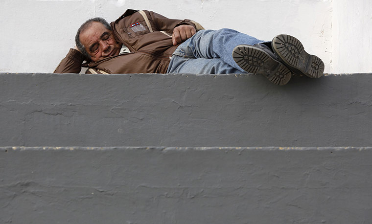24 hours in pix: A man takes a napat the Marsa Race Course in Malta