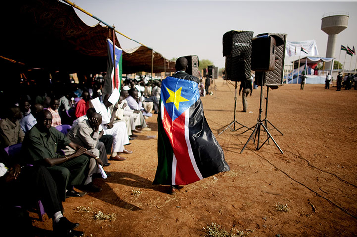 24 hours in pix: Southern Sudanese man wears the Sudan People's Liberation Movement flag