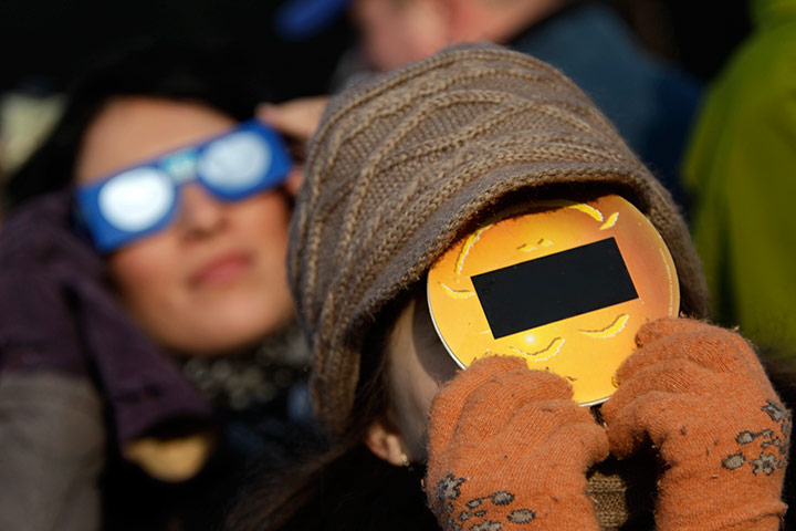 eclipse: People wear protective eyewear during partial solar eclipse in Bucharest