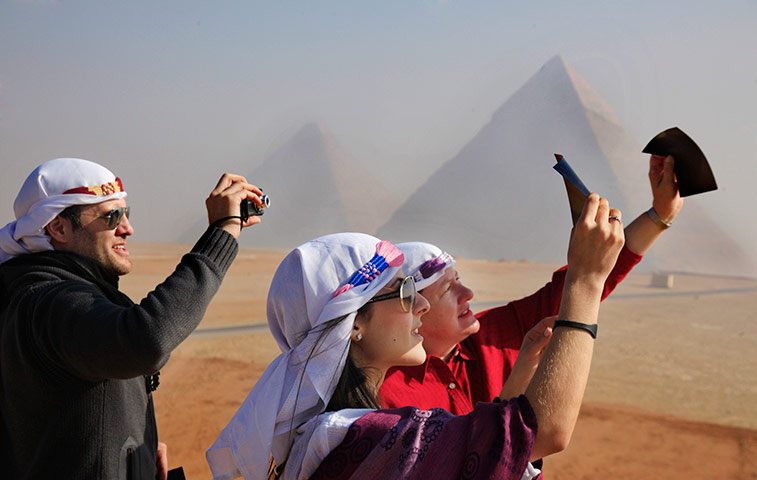 eclipse: Venezuelan tourists watch a partial solar eclipse in Egypt