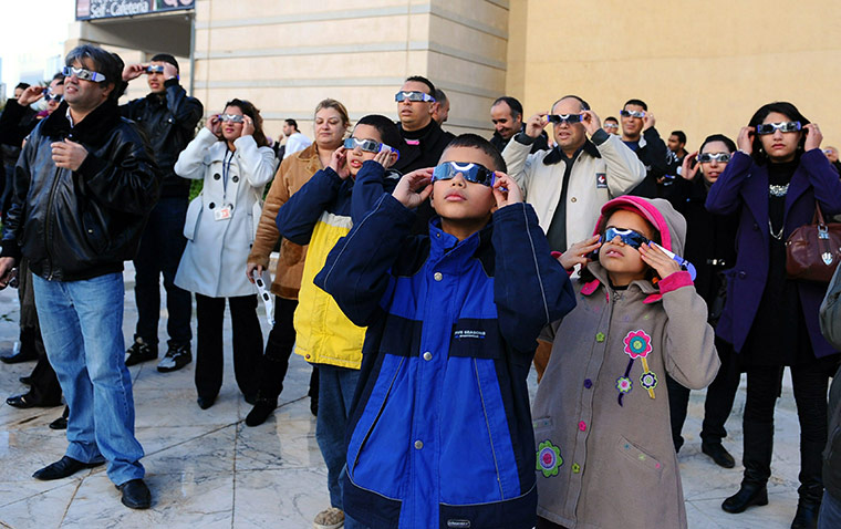 eclipse: People observe the partial solar eclipse in Tunis