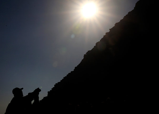 eclipse: A tourist take pictures of eclipse at the site of the Giza Pyramid