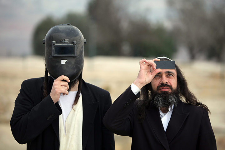 24 hours in pictures: Ultra Orthodox Jews view partial solar eclipse in Jerusalem