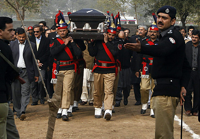 Salman Taseer Funeral: Pakistani police guards carry the coffin of the late Salman Taseer