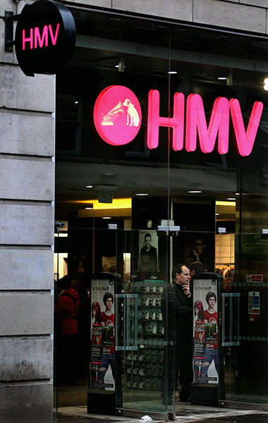 Week in business: A shopper stands in the doorway of an HMV store