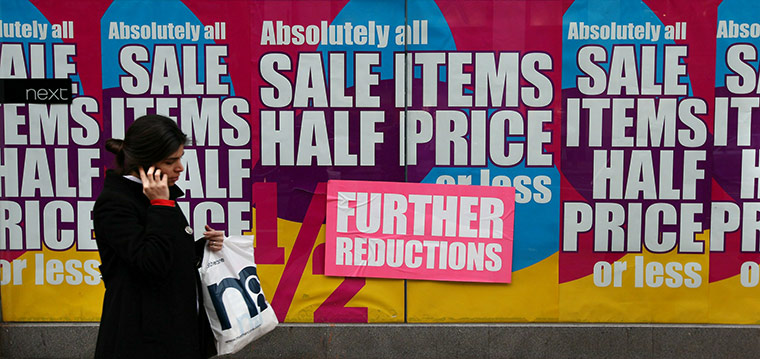 Business week in pictures: A shopper carrying a Mothercare bag walks on Oxford Street