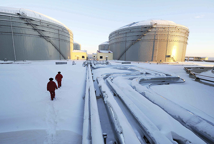 Business week in pictures: Workers inspect China and Russia's crude oil pipeline in Mohe, China