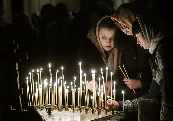 Orthodox Christmas: Lithuanian Orthodox Church believers light candles during the liturgy