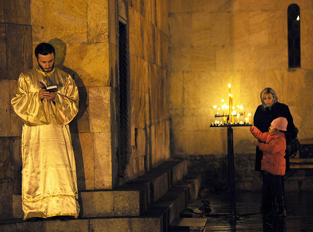 Orthodox Christmas: Georgian Orthodox priests attend the Orthodox Christmas service in a church