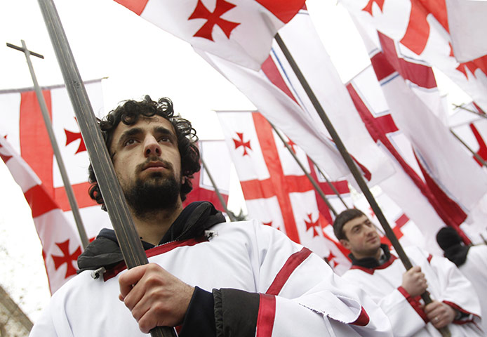 Orthodox Christmas: Participants march with national flags during a religious procession