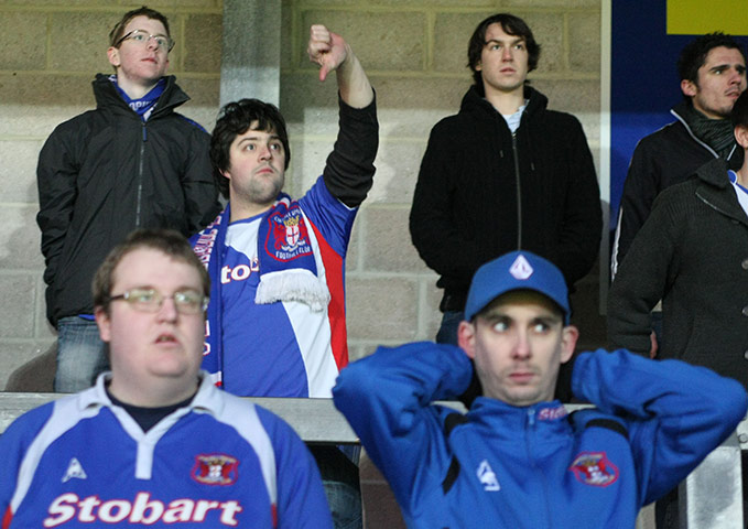 Torquay v Carlisle: Carlisle United fans show a look of dejection after their Cup exit