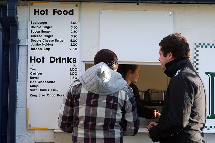 Torquay v Carlisle: Carlisle United supporters buy hot food and drinks inside the ground