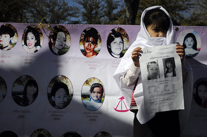 24 hours: Ciudad Juarez, Mexico: A girl holds a print-out of her missing sister