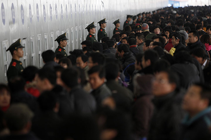 24 hours: Shanghai, China: Passengers queue up to buy train tickets 
