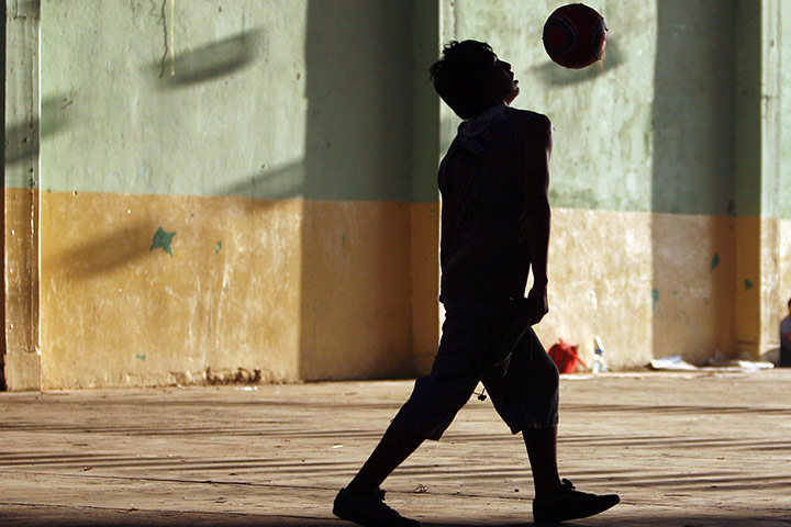 24 hours: Chahuites, Mexico: Jesus, a migrant from Peru, plays football at a shelter 