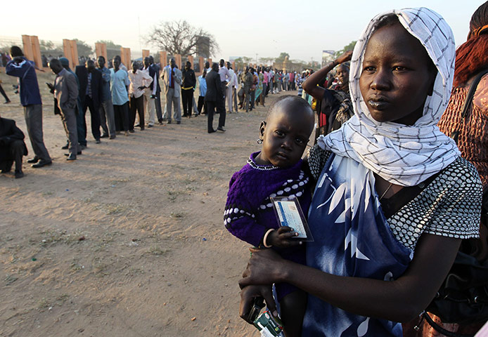 Sudan referendum: Southern Sudanese people queue to vote at a polling station in Juba