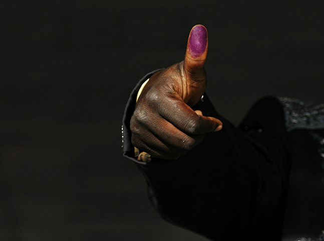 Sudan referendum: A southern Sudanese voter shows his inked thumb 