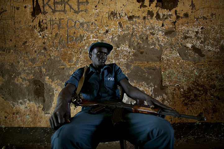 Sudan referendum: A southern Sudanese police officer on security detail at a polling station 