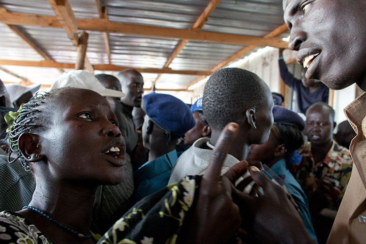 Sudan referendum: A southern Sudanese woman complains to a policeman about crowding 