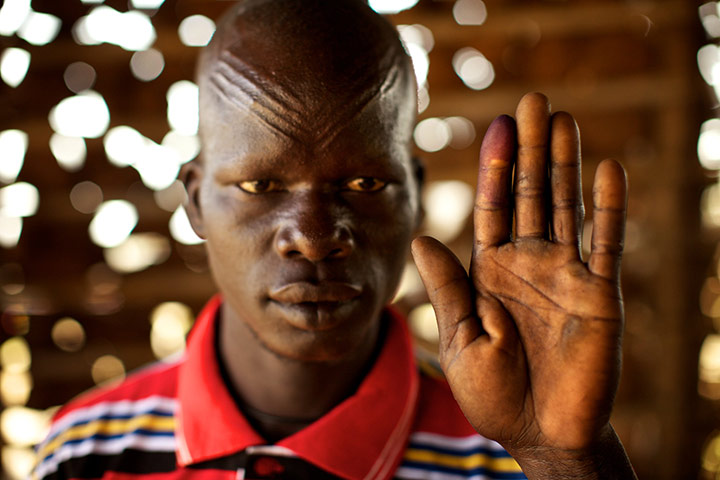 Sudan voters: Samuel Marsot holds up his ink-stained finger to show he voted