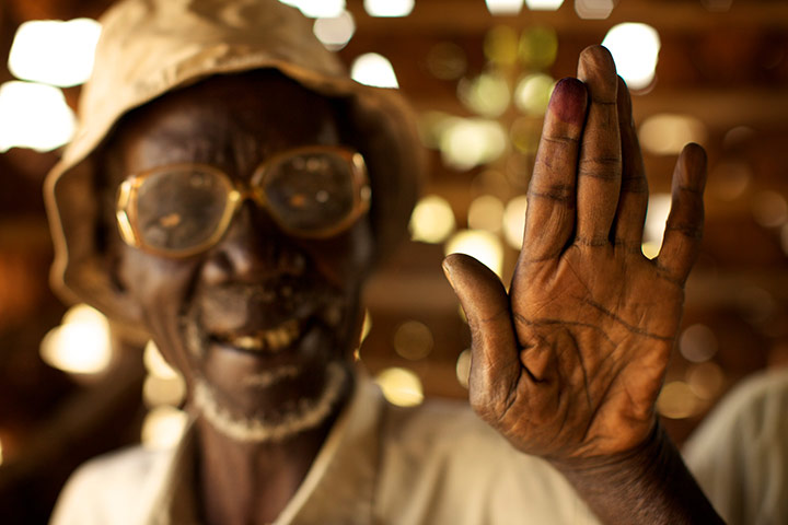 Sudan voters: Andrew Lowong holds up his ink-stained finger to show he voted