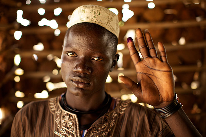 Sudan voters: James Kworis Juru holds up his ink-stained finger to show he voted