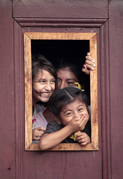 24 hours in pictures: children look through the window of their house in Masaya
