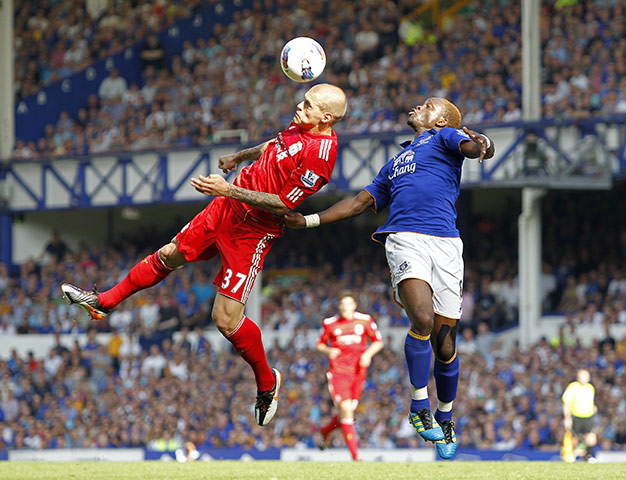 Saturday Roundup: Liverpool's defender Martin Skrtel beats Louis Saha in the air