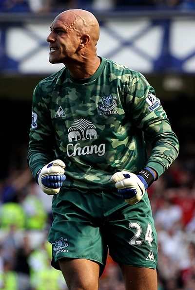 Saturday Roundup: Everton keeper Tim Howard celebrates after saving Dirk Kuyt's penalty