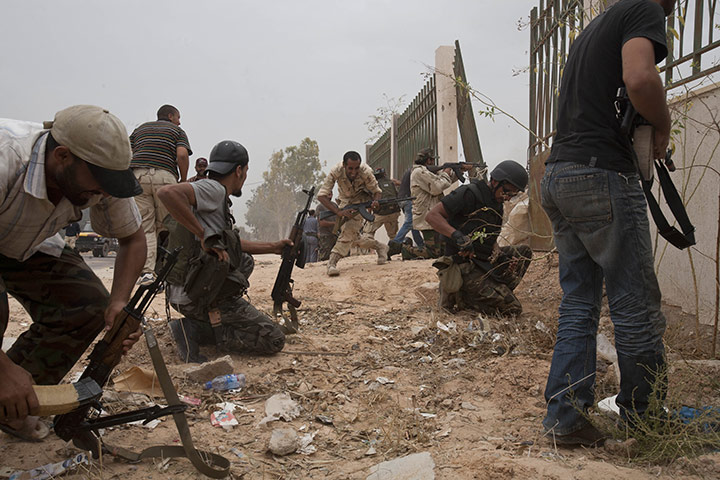 Sirte by Peter Beaumont: NTC fighters during a street batttle in Sirte, Libya