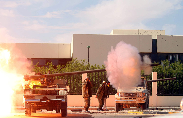 Sirte battles: Libyan rebels fire a rocket as they enter Sirte