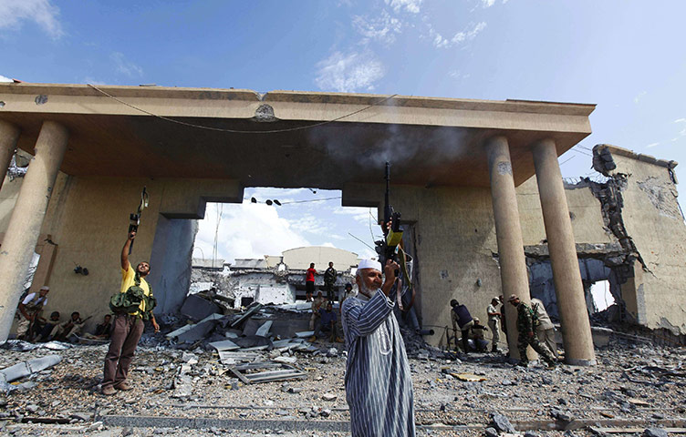Sirte battles: Anti-Gaddafi fighters fire shots at the Ouagadougou Conference Centre