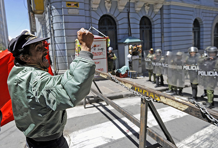 Bolivia Tipnis protests: 28 September: A man shouts slogans to riot policemen during a march