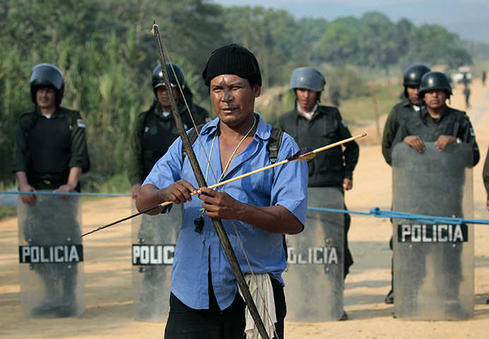 Bolivia Tipnis protests: 22 September: An indigenous man holds a bow and arrow in Yucomo