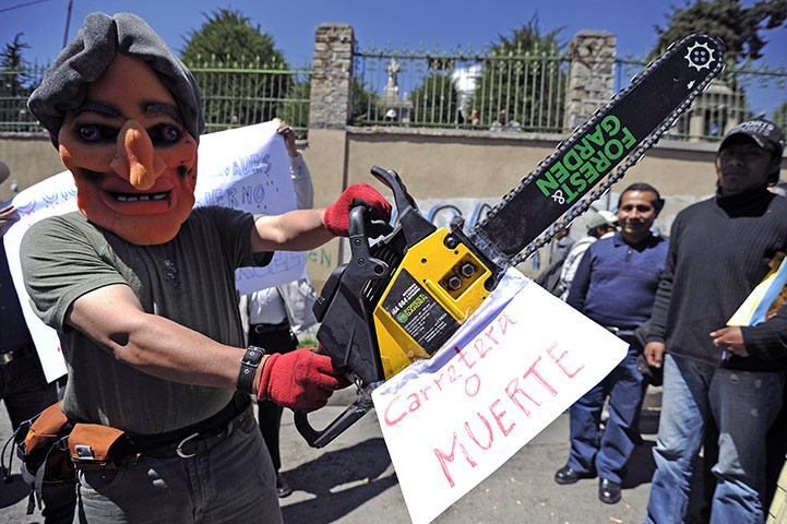 Bolivia Tipnis protests: 28 Septembee: A man wearing a mask depicting President Evo Morales 
