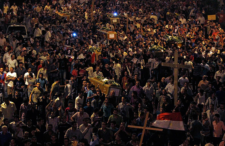 24 hours: Cairo, Eypt: Christians carry coffins on their way to Abassaiya Cathedral