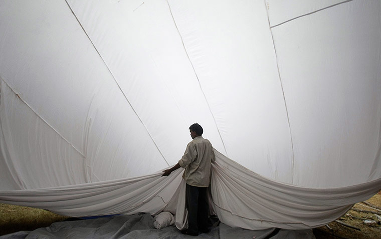 24 hours: Mumbai, India: A labourer constructs a temporary shelter