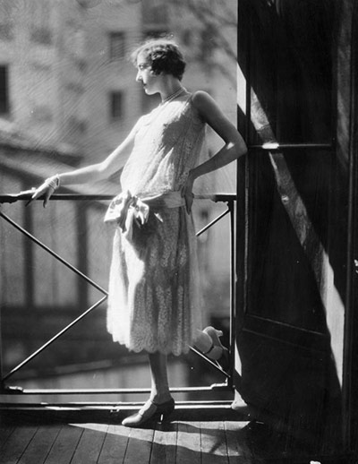 The history of lace: A woman modelling a typically twenties style grey silk and lace dress, 1924